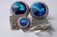 3289 c.1960s Dante silver tone mesh wrap cufflinks. Large Rivoli blue faceted crystal with fancy border. Lovely, large, and imposing! Measures about 7/8” diameter. Price: $45