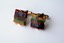 4354 c. 1960s multi-color stones laminate; pronged gold tone setting with hinged post; nice quality and unusual; Small/Med: approx. 5/8”x5/8” no makers mark ; Price: $35
